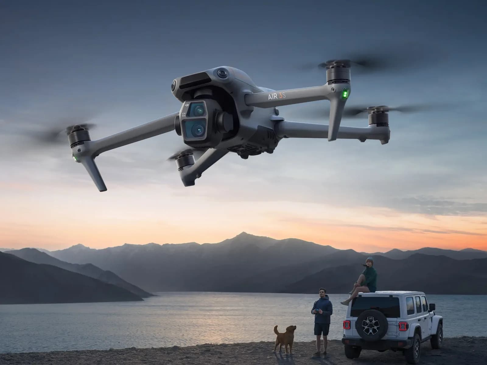 DJI Air 3S en vol au crépuscule au-dessus d'un lac de montagne